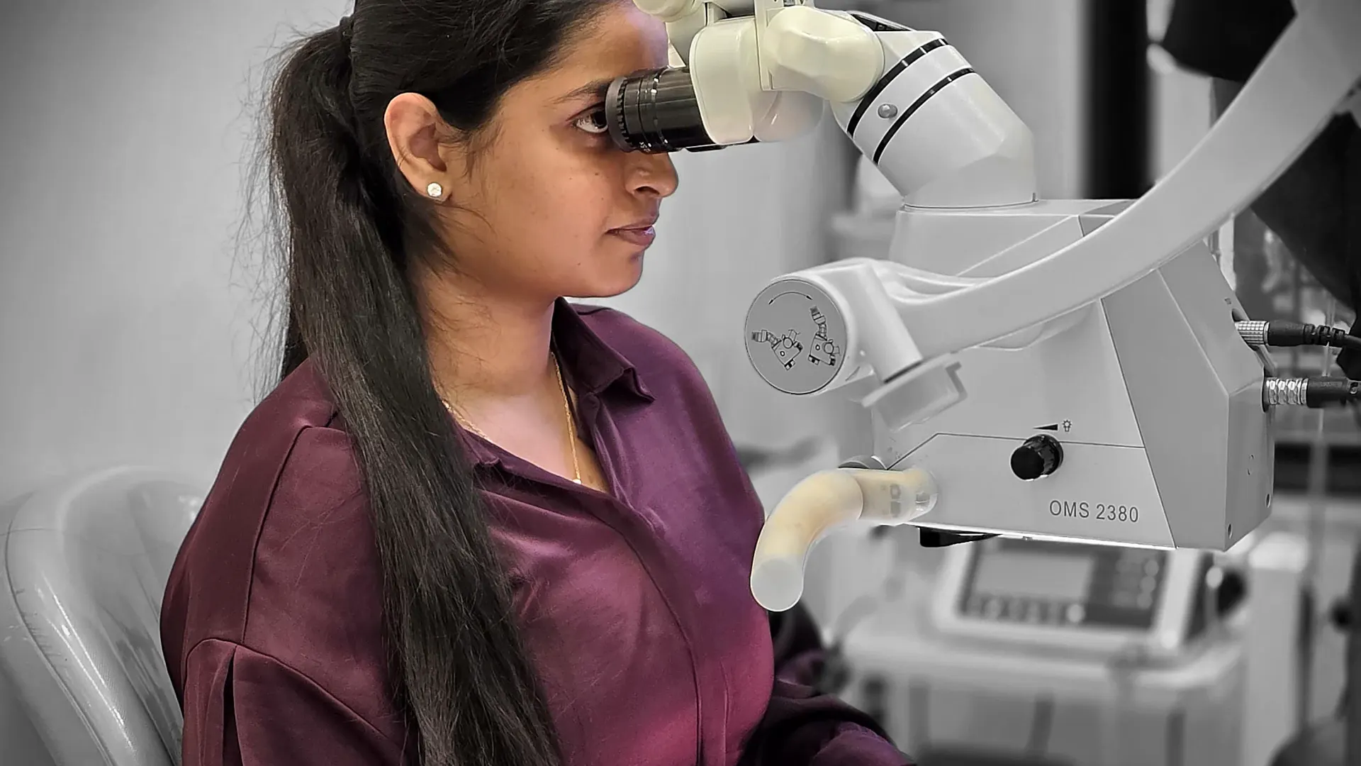 Dr. Apoorva working with microscope at White & Co. Dental Clinic