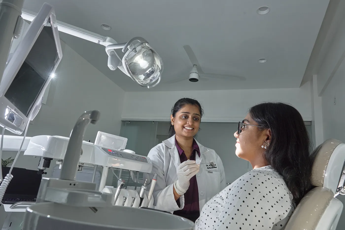 Dr. Apoorva discussing treatment with a patient at White & Co.